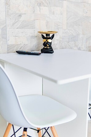 Cozy and minimalist dining area with comfortable seating, perfect for enjoying your meals or a cup of coffee in style.