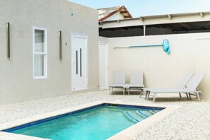 Another view of the serene pool area with ample space to unwind and enjoy the tranquil surroundings.