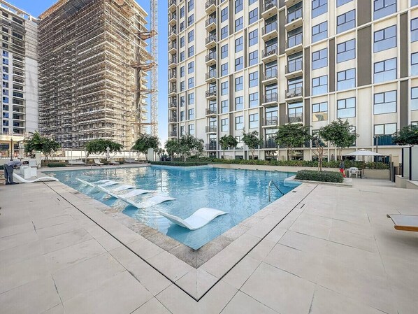 Pool Oasis: Dive into relaxation in a stunning pool surrounded by lush greenery and modern vibes!