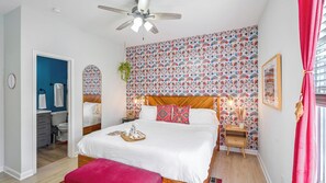 Relax in the downstairs master featuring a premium king bed, smart TV, and en suite bath-1 of 6 BRs