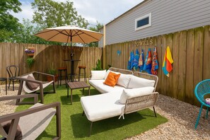 Unwind in your sunny private backyard with a cowboy pool, cozy seating, towels, and warm vibes