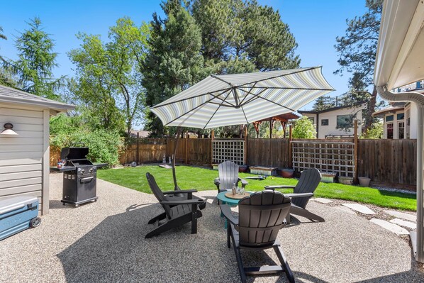 Backyard with Outdoor Lounge Area and Large Umbrella