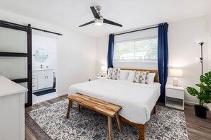 Modern bedroom featuring a spacious king bed, designed for comfort and relaxation in a stylish setting.