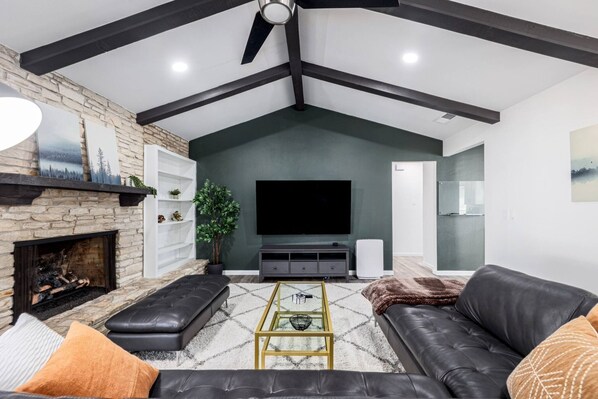 Relax in the living room with a massage chair and comfortable seating, ideal for watching TV or unwinding after a day in Austin.