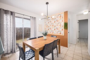 Light filled dining space with fun wallpaper to brighten up your day!