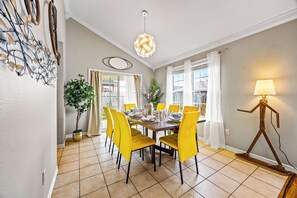 This large dining table, seating 8 here, can be extended to seat 10 people.