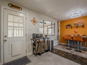 Mid-Century Modern accents and pops of vibrant color bring the dining area to life.
