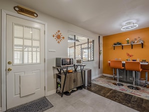 Mid-Century Modern accents and pops of vibrant color bring the dining area to life.