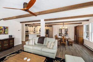 The open-plan living room, dining area, and kitchen allow for easy movement and conversation 