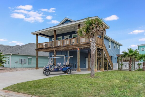 House, golf cart, driveway for 4 cars and boat, empty lot adjacent

