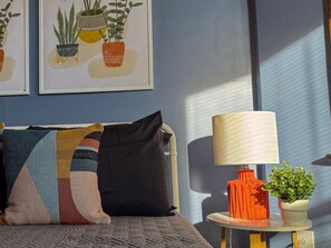 You feel enveloped in comfort as you relax on the queen bed, surrounded by a room designed for tranquility.