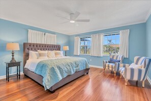 Primary bedroom with king bed, attached bathroom and 40-inch Smart TV