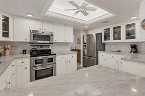 Bright, fully-equipped kitchen with plenty of countertop space and new stainless-steel appliances