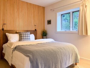 Bedroom #1 offers a queen bed with private porch and creek views.