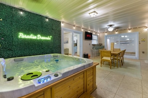 Cozy up in the hot tub, then toast to the night at your outdoor table. 