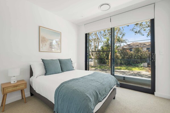 Bedroom 3: A stylish double bedroom with a built-in wardrobe and a serene balcony, offering a peaceful spot to unwind and take in the surroundings.