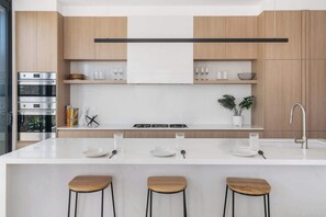 Chefs Kitchen with large walk-in pantry: Spacious kitchen with a large island bench, offering a perfect spot for casual dining and entertaining.