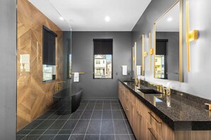 The master bathroom is a modern dream - complete with heated floors, lighted mirrors, a soaking tub and walk -in shower!