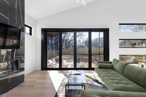 Tons of natural lighting brighten this living space. Equipped with screen doors that open onto the back yard for those warm summer breezes as well as a cozy fireplace for the cooler evenings, this room is the perfect spot for all seasons.