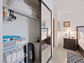 Master bedroom closet with pack and play and extra linens