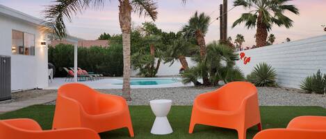 A private backyard oasis with pool and outdoor seating