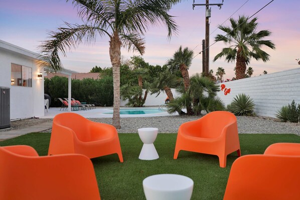 A private backyard oasis with pool and outdoor seating