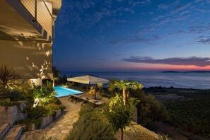 Evening view of private heated pool, pool patio and sun loungers in Luxury Villa Energy Orebic - Peljesac with sea view 