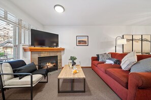 The living area is bright and inviting, offering plenty of space for relaxing. 