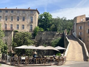 terrasse de café et la montée du château qui amène au gîte.