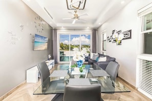 Dine or unwind in this bright open-concept space with views of the pool and sky.