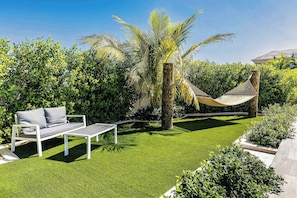 Relax in the hammock or enjoy a quiet morning coffee in this garden nook.