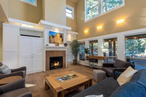 The living room has large windows to let in lots of natural light.