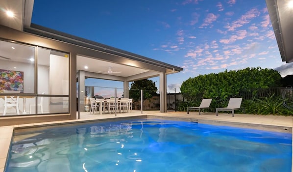 Enjoy a refreshing swim or relax in the private heated pool, nestled among lush greenery.