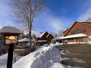 The apartment is a standalone rental property separate from the main Slopeside Estate House, on the second floor of a detached garage building (not used for vehicles). It offers independence while sharing the same premier address.