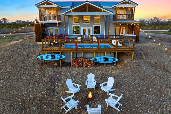 A riverfront cabin with a heated pool, hot tub, and games for the family