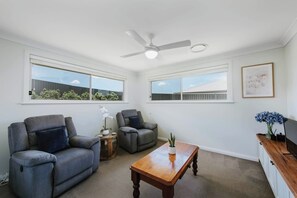 Kick back and relax in the cosy living room with recliners, ceiling fan and ducted air conditioning for year-round comfort.