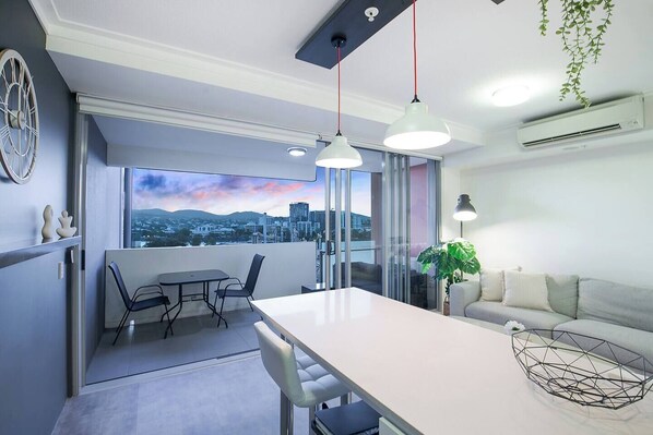 Enjoy meals indoors or al fresco on the balcony while soaking in the sunset and skyline views.