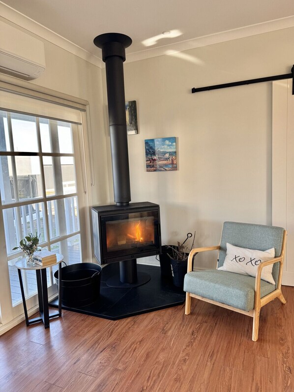 Wood log fireplace ready and set up for your arrival