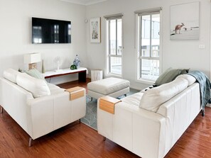 Open plan light fill lounge room with ocean views, 55 inch SMART and free to air TV