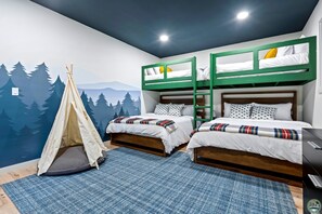 Our custom bunk room has 2x twin over queen beds plus a teepee and childs table