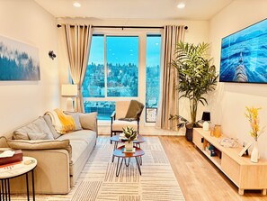 Relax in a cozy living room with a 65" 4K TV and popcorn maker for movie nights!