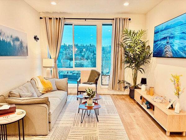 Relax in a cozy living room with a 65" 4K TV and popcorn maker for movie nights!