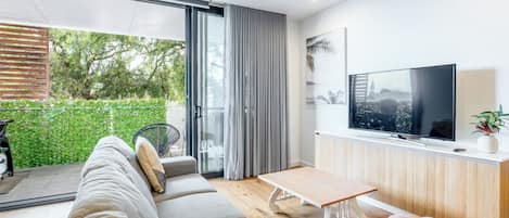 Bright and comfy living room with a TV, perfect for movie nights too!