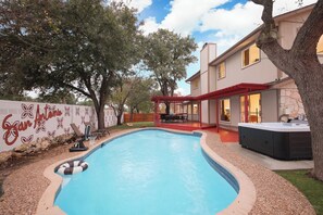 Escape to your private backyard oasis—featuring a sparkling pool, relaxing hot tub, outdoor patio, and dining area. Resort-style living at its finest! 