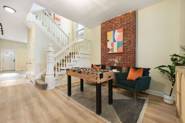 Spacious Game Room with Foosball Table and Comfy Couch