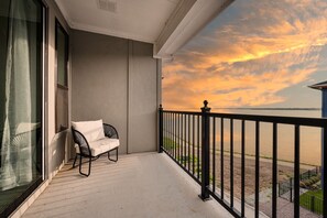 Outdoor seating on balcony with lake view