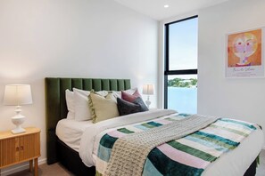 The Queen bed looks inviting and comfortable with its nature colours.