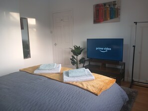 Master bedroom has hanging space for clothes, mirror, hairdryer and 43" HD TV
