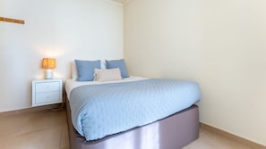 This charming double bedroom is designed for restful nights, with light tones and soft bedding for ultimate comfort. #PeacefulRetreat #CoastalVibes
