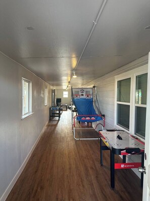The indoor Gameroom features various games like a Ice hockey and basketball.